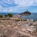 Ancient stone columns and architectural remains near the Mediterranean Sea at Nora Archaeological Park in Sardinia, Italy